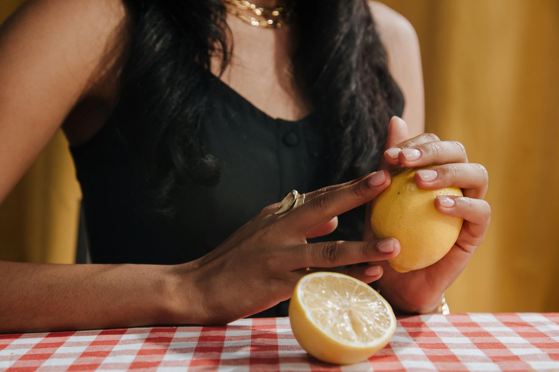 Two happy women laughing together with fresh lemon slices, representing joyful intimacy and connection