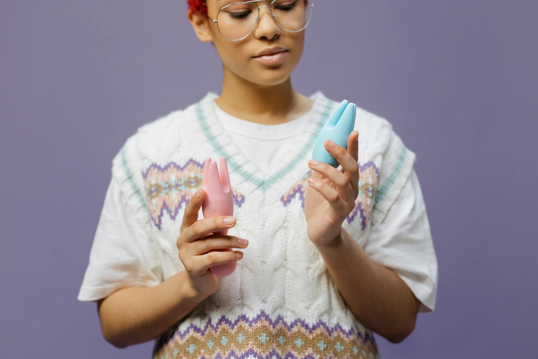 A couple holding a blue vibrator together, showing intimacy and shared pleasure